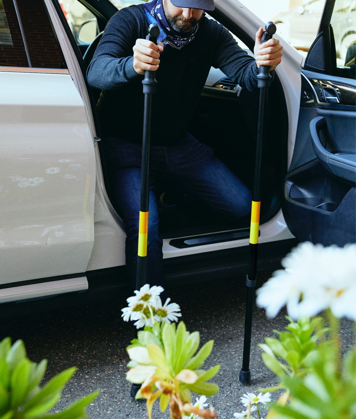 Photo of person exiting a vehicle using Upperstate poles to help balance.